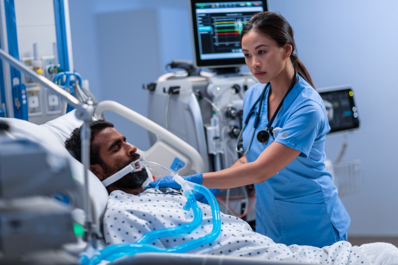 Physician working in an ICU department to care for ill patient