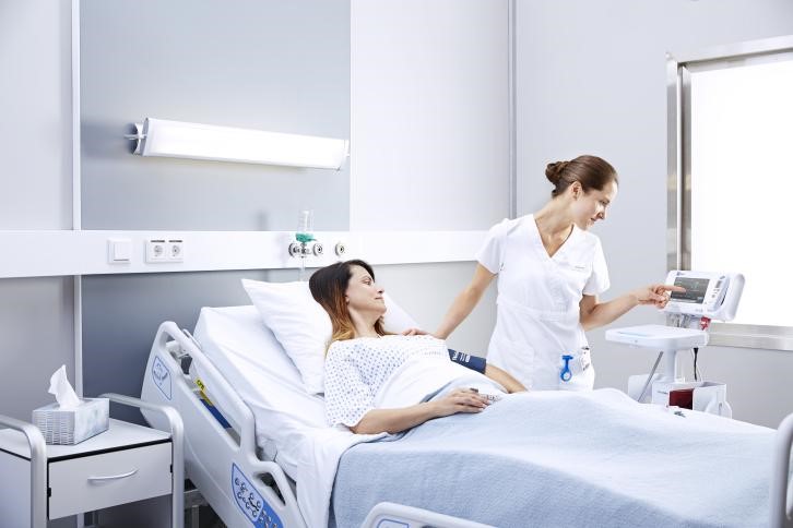 Physician working in a medical surgery department to care for ill patient