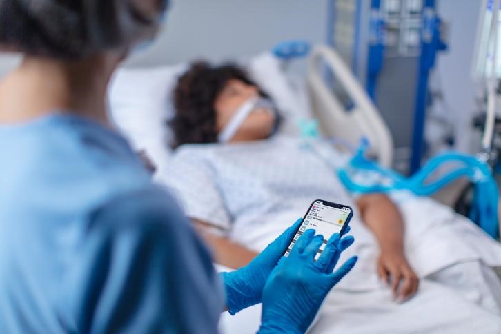 Nurse using a medical connected care device