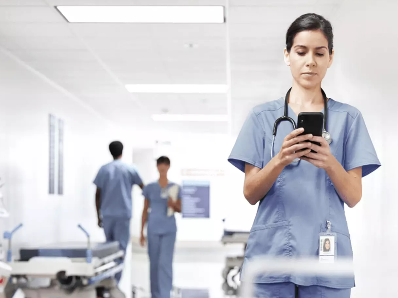 Nurse using voalte mobile in a hospital.