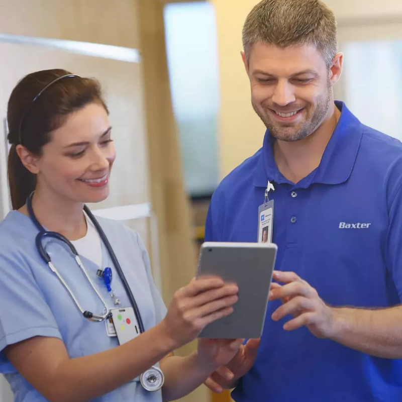 two members of staff looking at an ipad