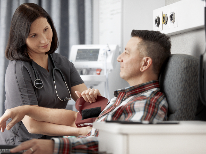 A doctor checking a patients blood pressure.