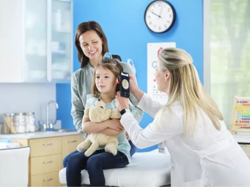 A doctor using the Macroview Otoscope on a young patient.