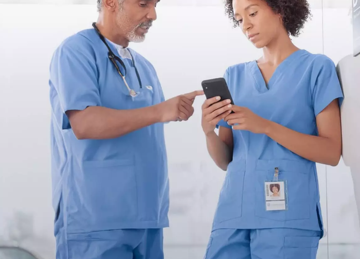 Two doctors looking at the voalte mobile product.