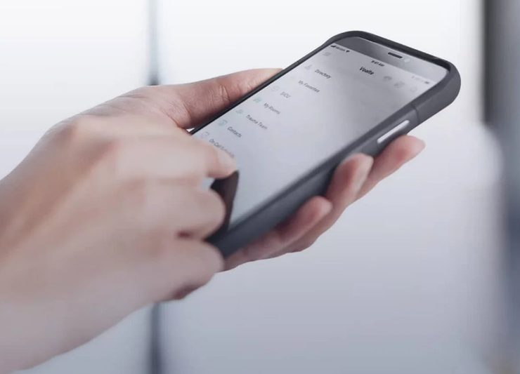Someone holding a phone displaying the voalte mobile dashboard.