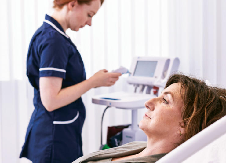 Nurse managing a patient monitor 