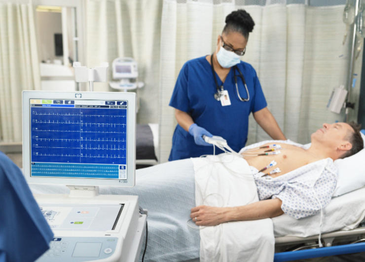 A nurse tending to a patients cardiology.