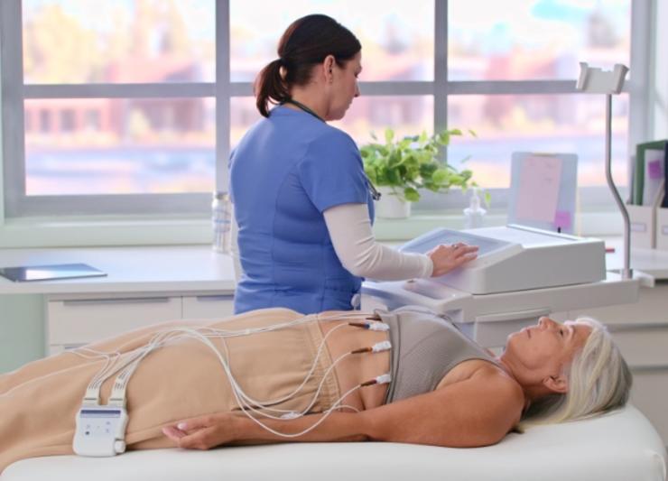 A doctor inspecting a patients cardiology.