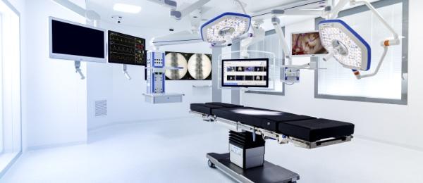 An operating room with multiple high-tech devices.